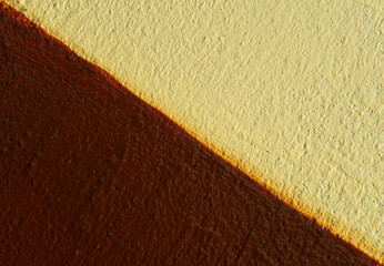 Abstract yellow color and brown color of wall texture background with copy space for design and decoration. Two-tone background fashionable glamorous divided into two parts.