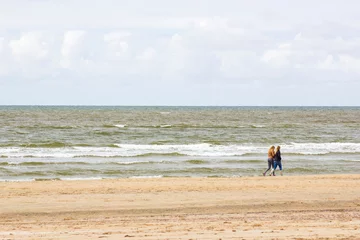Gardinen Silhouettes on the beach in the Netherlands © Mira Drozdowski