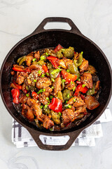 Chinese Stir-Fried Chicken and Vegetables in a Wok Top Down Vertical Photo on White Background