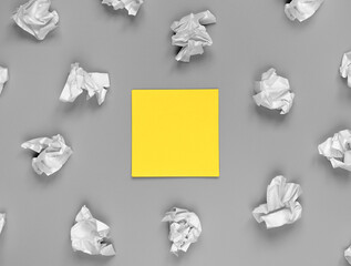 Bright creativity concept, yellow sticker and crumpled papers. background in color of the year