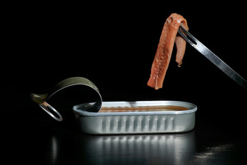 Cantabrian anchovies in can with black background
