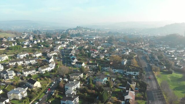 Early morning mist over suburban neighbourhood in town - drone shot