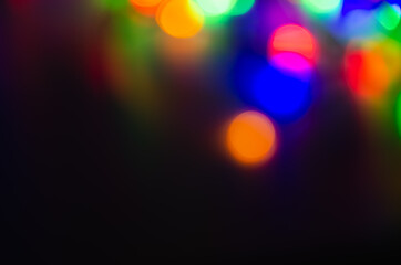 Fototapeta premium Abstract pattern of colorful bokeh lights on dark background