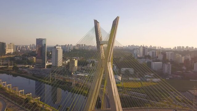 close drone flight over estaiada bridge in S&atilde;o Paulo during a sunset on a busy day