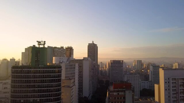 flight over City centre Of Sao Paulo, near some buildings at sunset