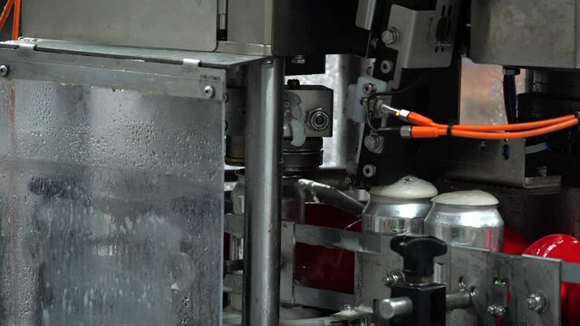 Canning line at brewery capping beers