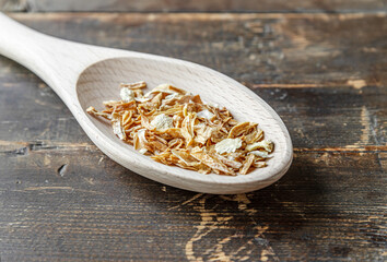dried onions spice on a wooden spoon