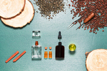 On the table are placed items and ingredients for the production of perfume compositions with a bright spicy woody aroma.