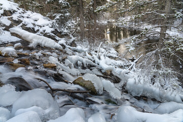 Icy creek flowing in winter season. Grassi Lakes, Canmore, Alberta, Canada.