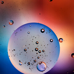 Small air bubbles in a big oil sphere, blue and red colors