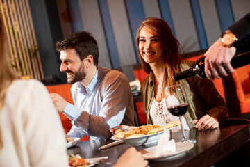 Young people having dinner in the restaurant