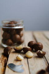 Beautiful macadamia nuts on wooden background