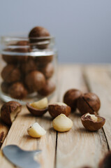 Beautiful macadamia nuts on wooden background