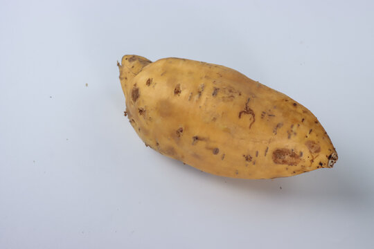 Ubi jalar kuning or yellow sweet potato on the pandanus mat. Selective focus