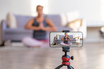 Live streaming on a smartphone - online yoga lesson.