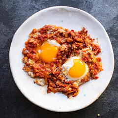 fried eggs with tomato and vegetables shakshuka omelette natural organic snack ready to eat on the table healthy meal snack top view copy space for text food background rustic keto or paleo diet