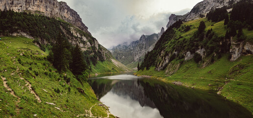 Swiss alpine lake, lake high in the mountains, between two cliffs, cloudy dramatic sky, Hoher Kasten (Appenzeller Alpen)