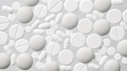 Various white medical pills on white background
