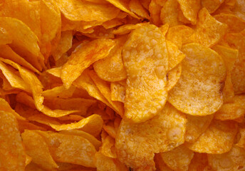 Potato chips or crisps . Close-up of potato chips or crisps. Food background.