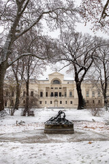 Beautiful Liechtensteinpark in Vienna, Austria and its fountain in the middle of the empty pond in the first snow.
