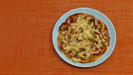 homemade pizza on a white background in a blue plate 
