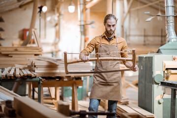 Carpenter with vintage handsaw