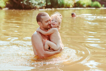 the father with the child in the water
