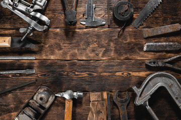 Carpenter tools on the old wooden workbench flat lay background with copy space.