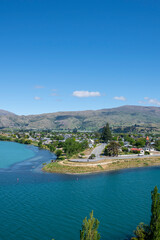 Central Otago town of Cromwell on bend in turquoise  Clutha River in Central Otago New Zealand.