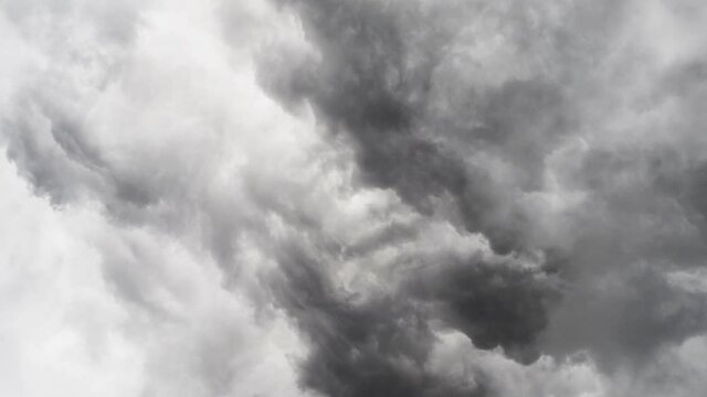 zoom in in a thunderstorm inside the gray and dark cumulus cloud