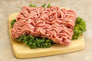 Raw pork minced meat over board