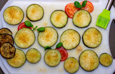 Eggplants cut into slices and prepared for baking
