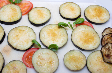 Eggplants cut into slices and prepared for baking