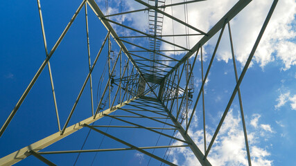 BOTTOM UP: Metal construction of an electricity pylon soars into the clear sky.