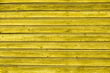 Wooden background toned in yellow. Color 2021 illuminating