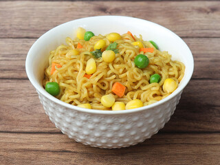 Mixed Veg Maggie Noodles, Instant Noodles cooked with veggies and then served in a bowl over a...