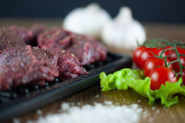 fresh grilled meat with cherry tomatoes, lettuce, garlic and seasonings