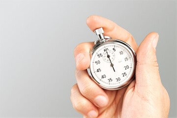 Silver classic stopwatch in human hand