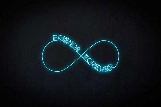 Friends Forever Text and Infinity Sign as Neon Blue Light Display Against Black Wall.