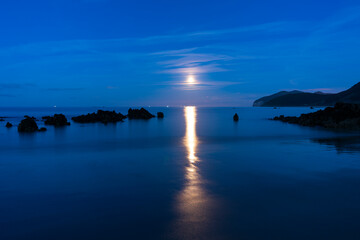 Obraz premium The Moon in Trengandin beach, Noja, Marismas de Santoña, Noja y Joyel Natural Park, Cantabrian Sea, Cantabria, Spain, Europe