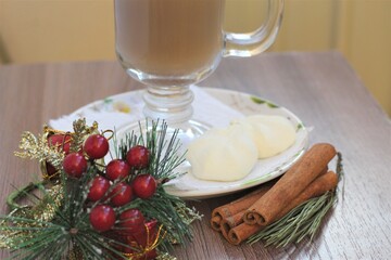 glass of coffee and christmas decoration and cinnamon