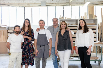 Team of designer and coworker standing side by side at workshop