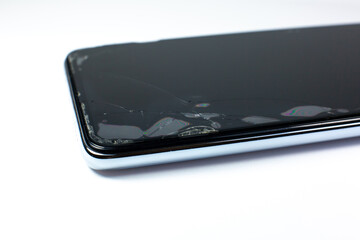 Broken protective glass on the smartphone screen.