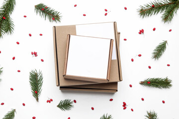 Blank cardboard boxes on the table in festive Christmas setting. Simple gift box with copy space.