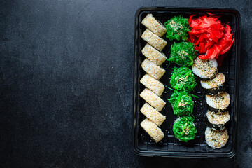 sushi rolls set salmon, trout, tuna, tobiko caviar, nori and more natural organic snack ready to eat on the table healthy meal snack ingredient top view copy space for text food background rustic