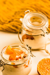 Orange and sea-buckthorn homemade yoghurt in glass jars . Orange and white. Colorful food