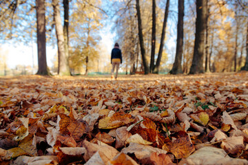 Woman walking in public park on sunny day