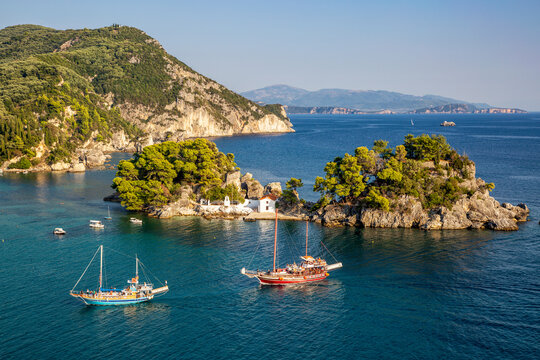 Greece, Preveza, Parga, Ships sailing in front of Panagia Chapel in summer