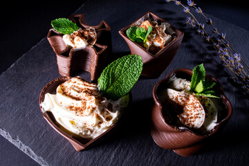cups printed on a 3D printer with chocolate, whipped cream and mint leaves