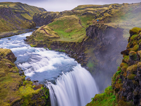 Scenic View Of Waterfall On Green Landscape